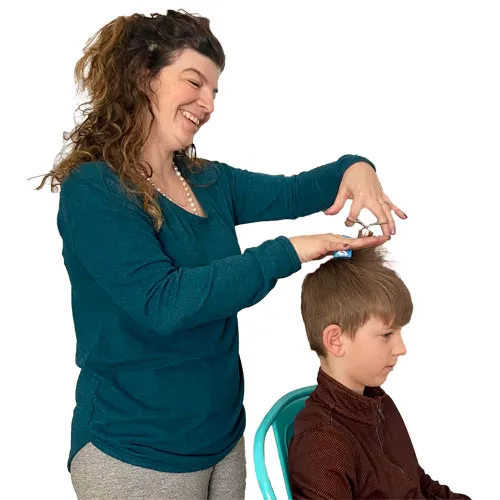 Picture of a mom giving a child a HairFin haircut